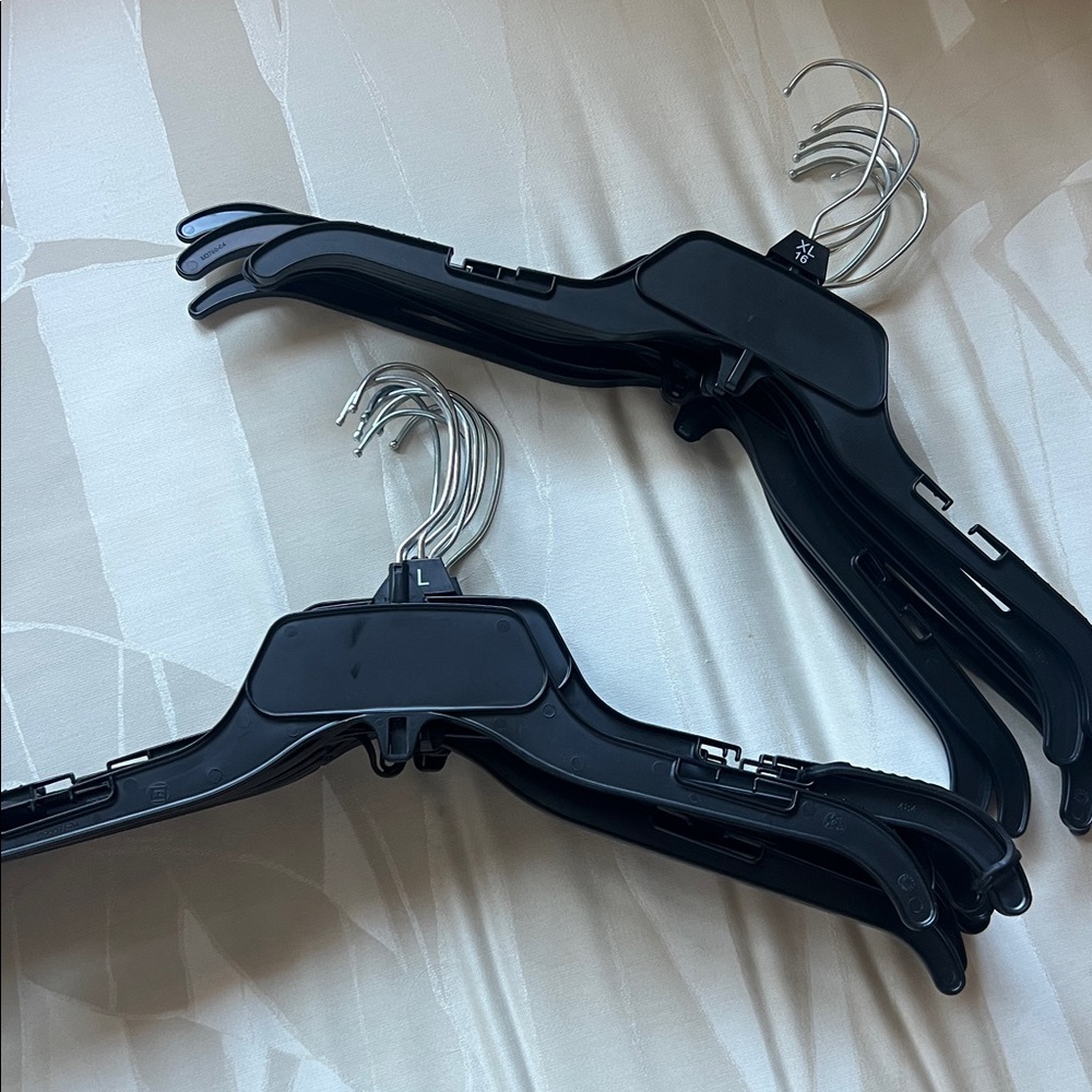 Set of 14 Black Plastic Hangers and 6 hangers for skirts or pants with clips.